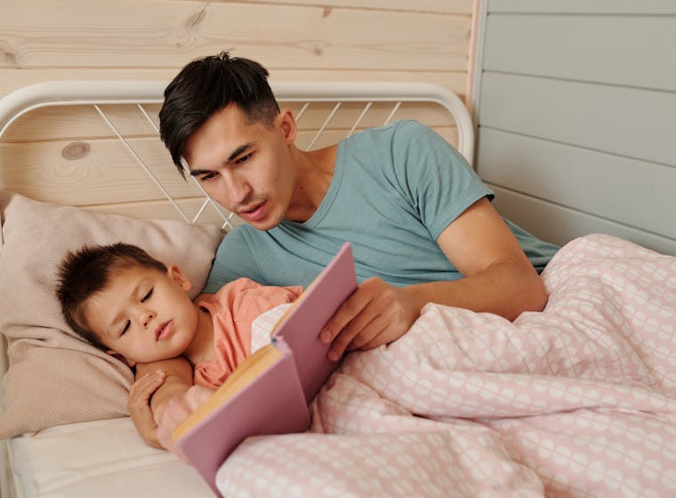 A parent reading a bedtime story to their child